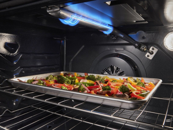Sheet pan of roasted vegetables under a broiler element