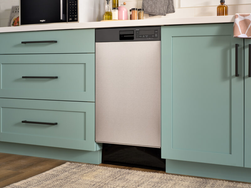 An 18" Whirlpool® Dishwasher in mint green cabinetry