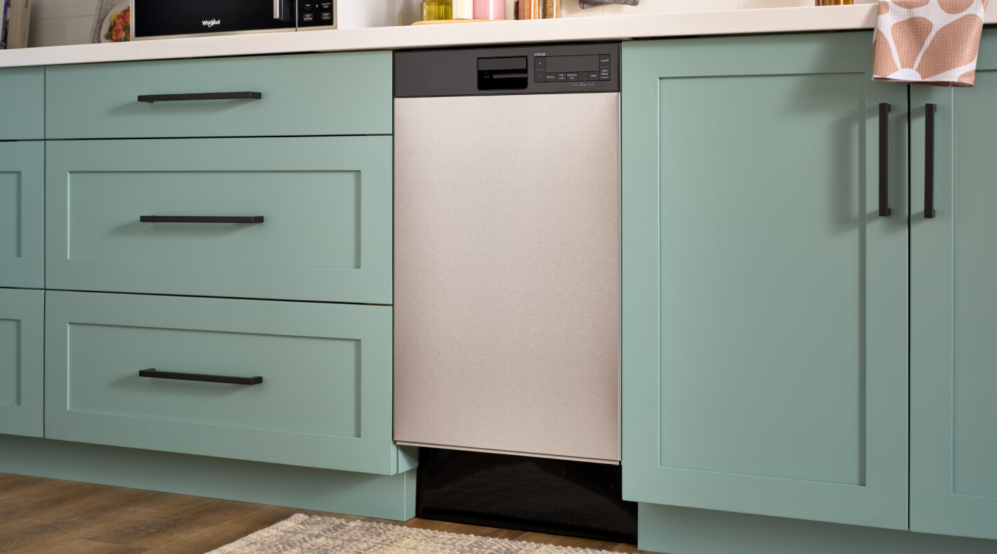 An 18" Whirlpool® Dishwasher in mint green cabinetry