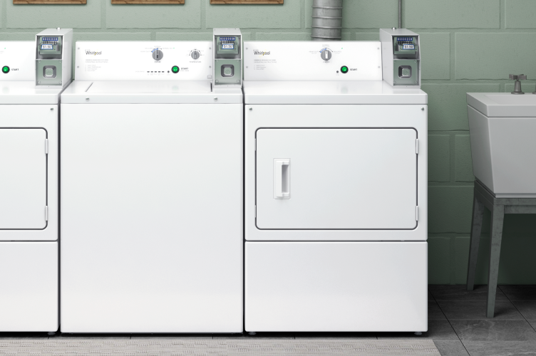 A Whirlpool® commercial laundry set in a laundry room.