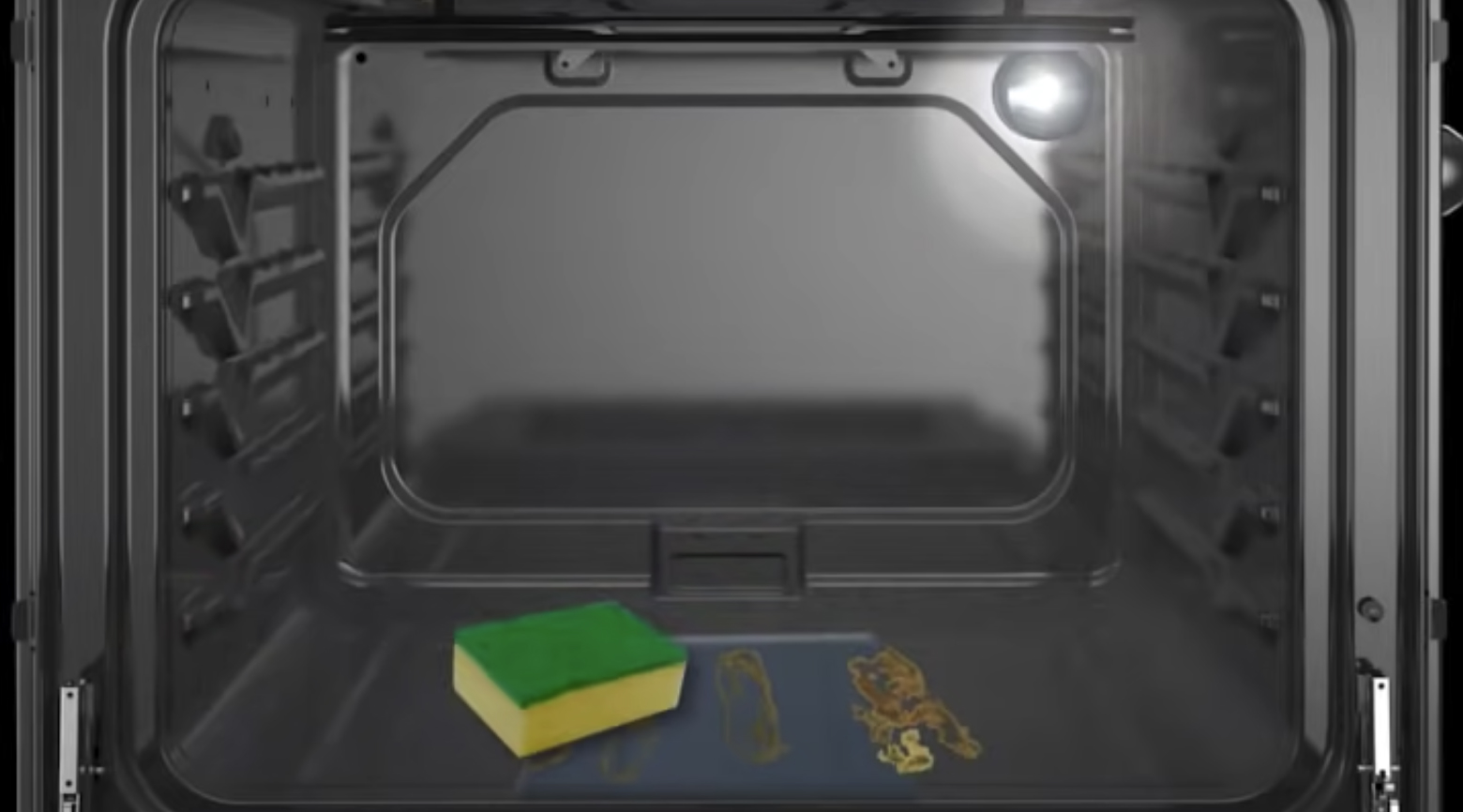 Sponge wiping dirt and water from oven cavity