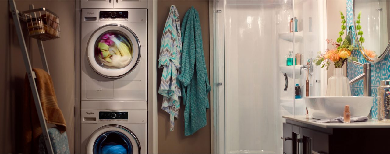 A Whirlpool® front load laundry set stacked in a bathroom.