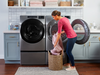 Person loading a Whirlpool® Dryer