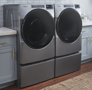 Whirlpool® front load laundry set in a bright laundry room