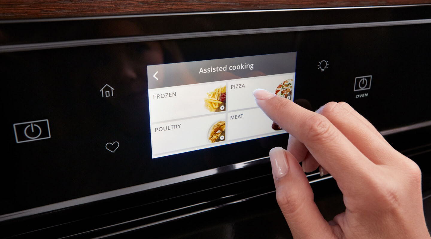 Person touching a Whirlpool® oven touchscreen control panel