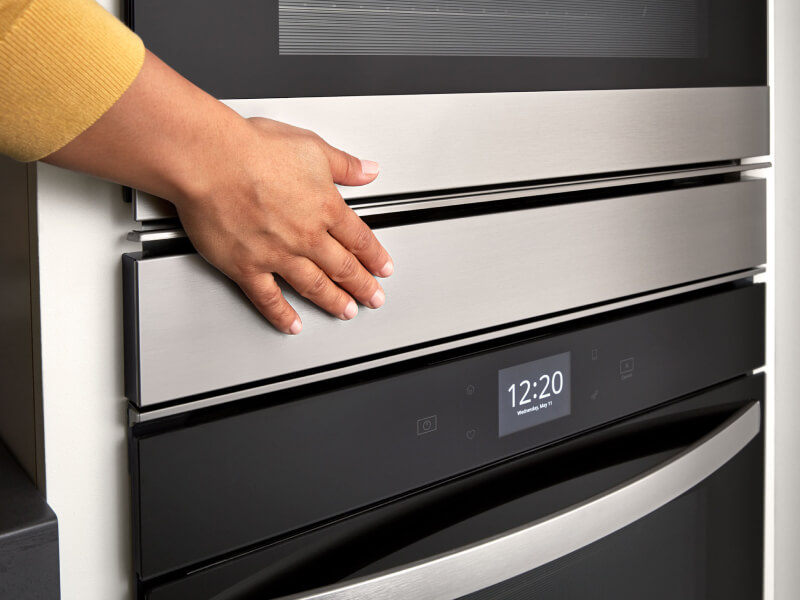 Hand touching a Whirlpool® double wall oven