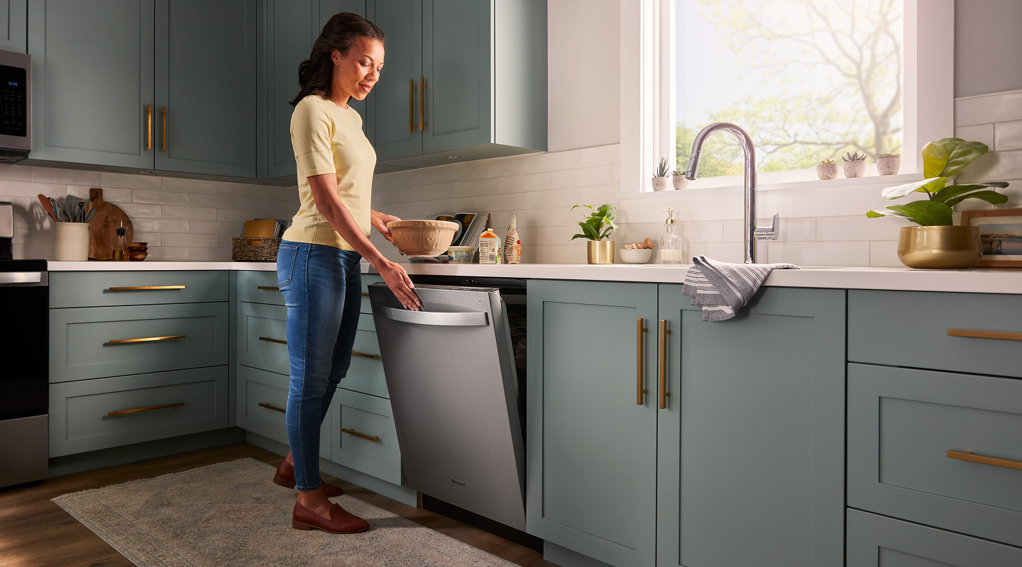 Person closing a top control dishwasher