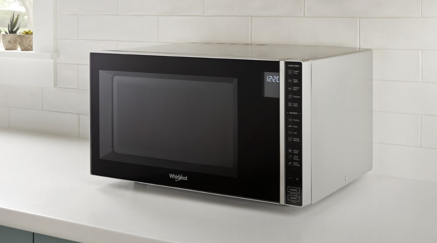 Whirlpool® Countertop Microwave in front of white backsplash