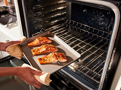 Putting salmon into the oven