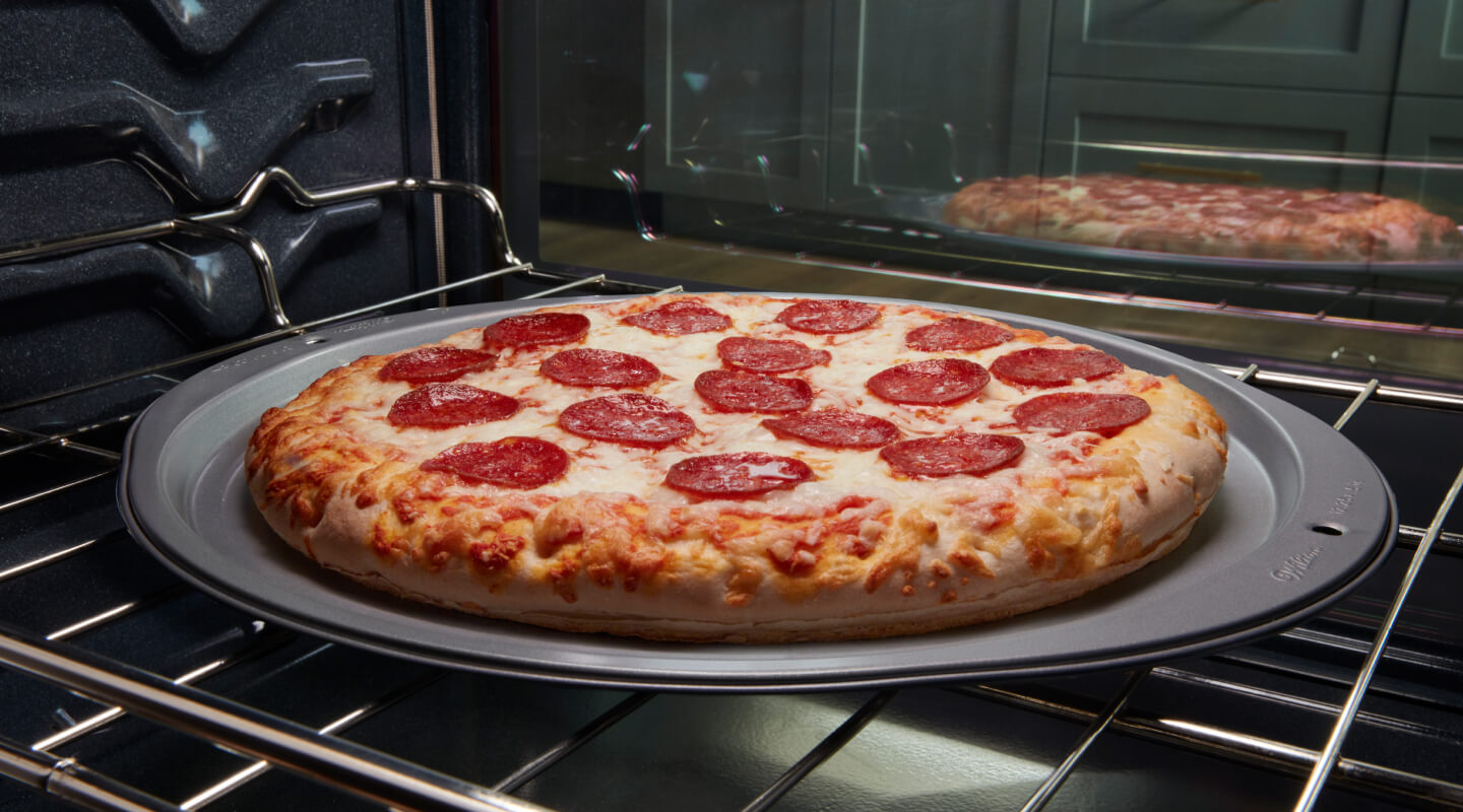 A pizza baking in an oven