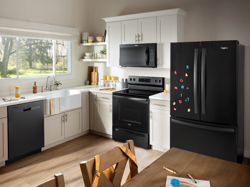Black kitchen appliances in a bright kitchen