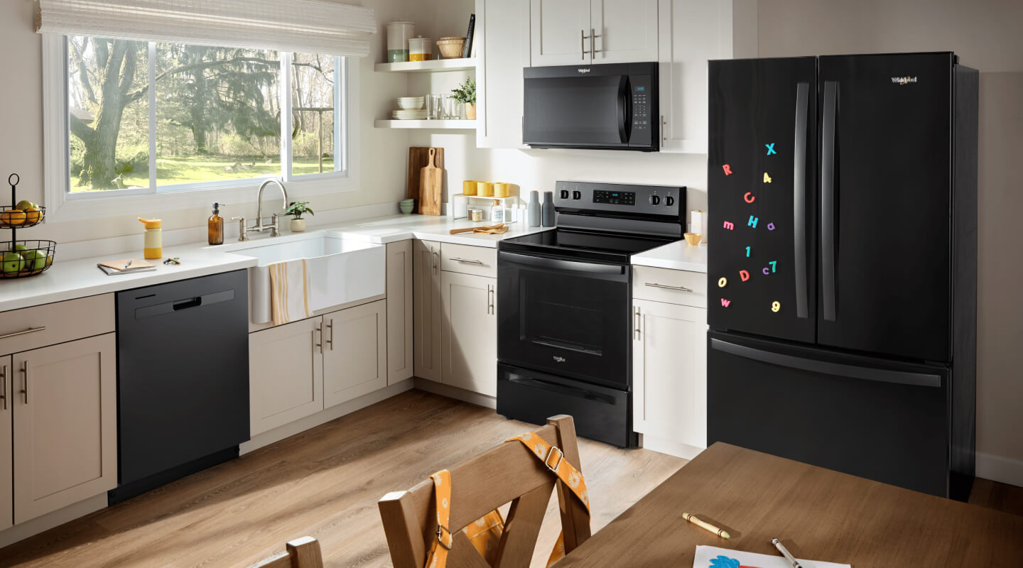 Black kitchen appliances in a bright kitchen