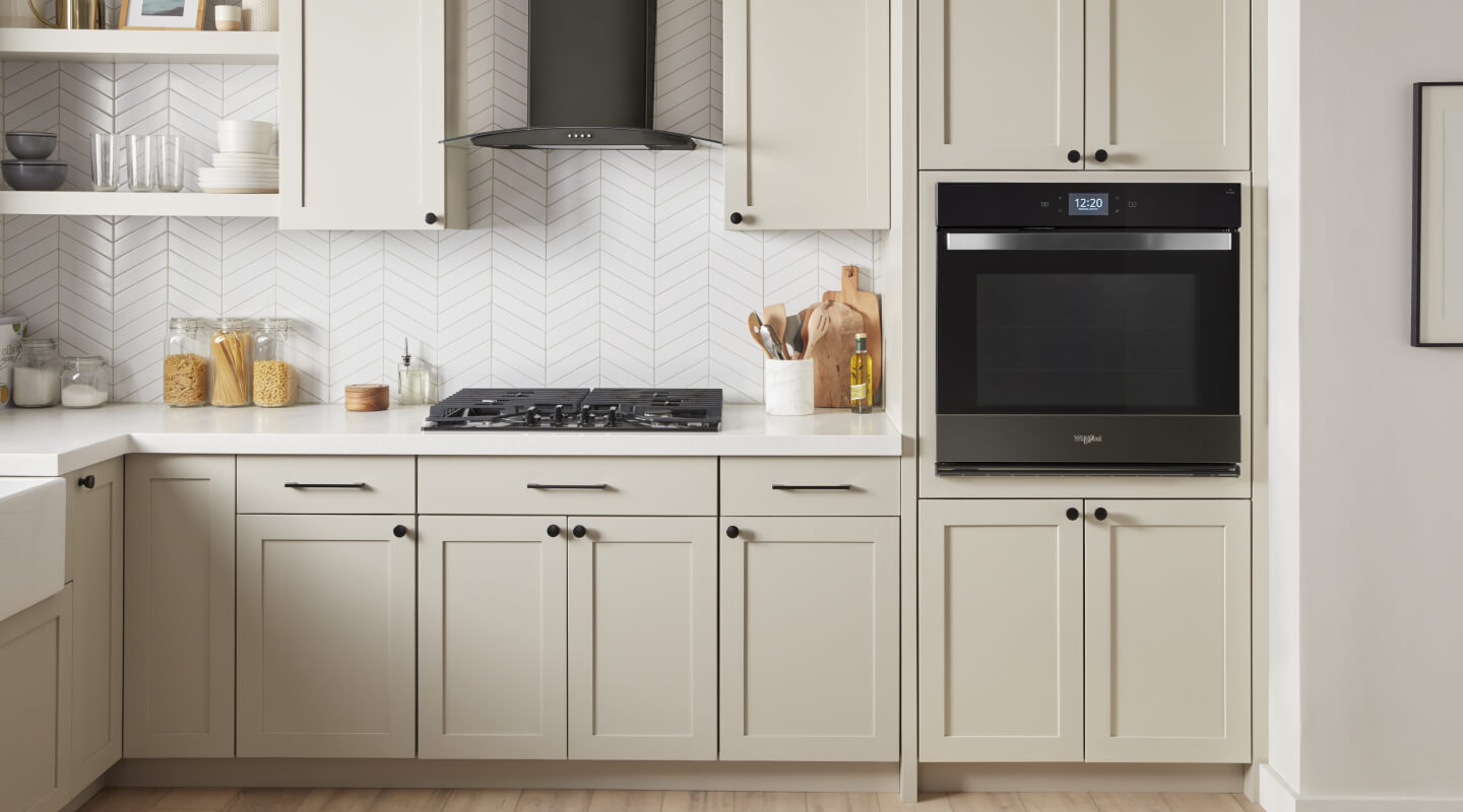 Whirlpool® Single Wall Oven and Gas Cooktop in kitchen with cream-colored cabinetry