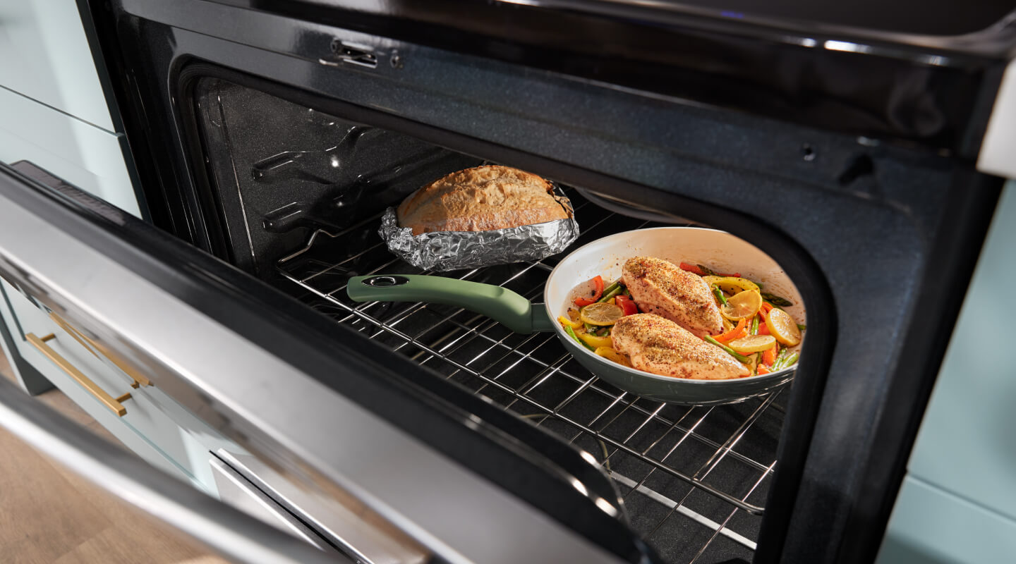 One pan meal and bread inside an oven