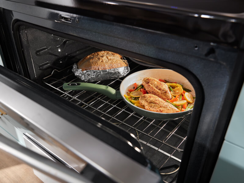 One pan meal and bread inside an oven