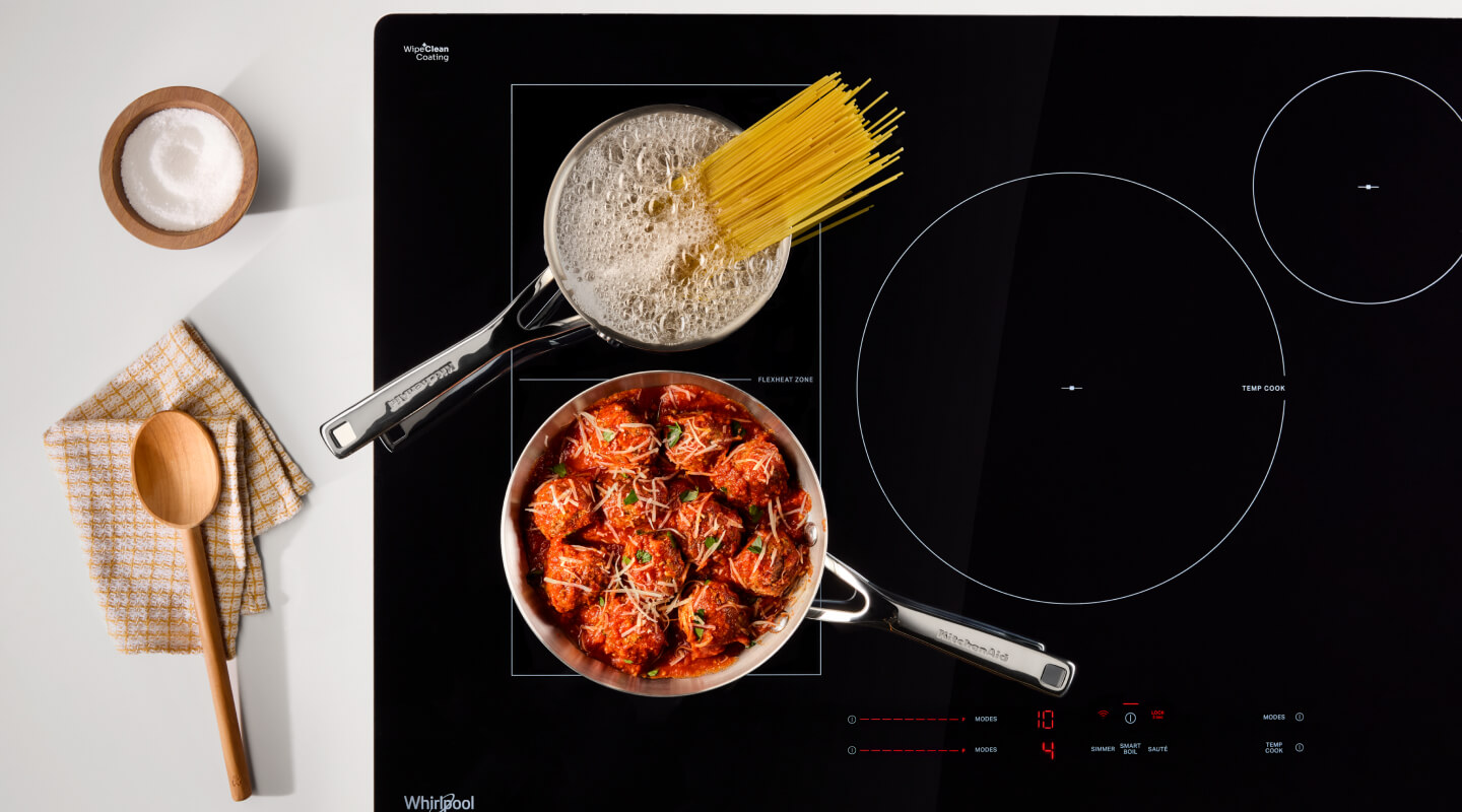 Noodles and meatball cooking on an induction cooktop