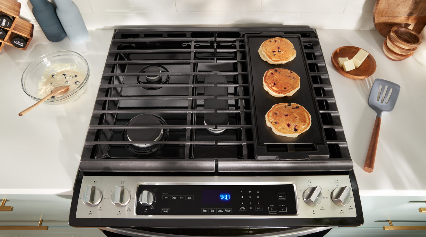 Pancakes cooking on a stovetop griddle