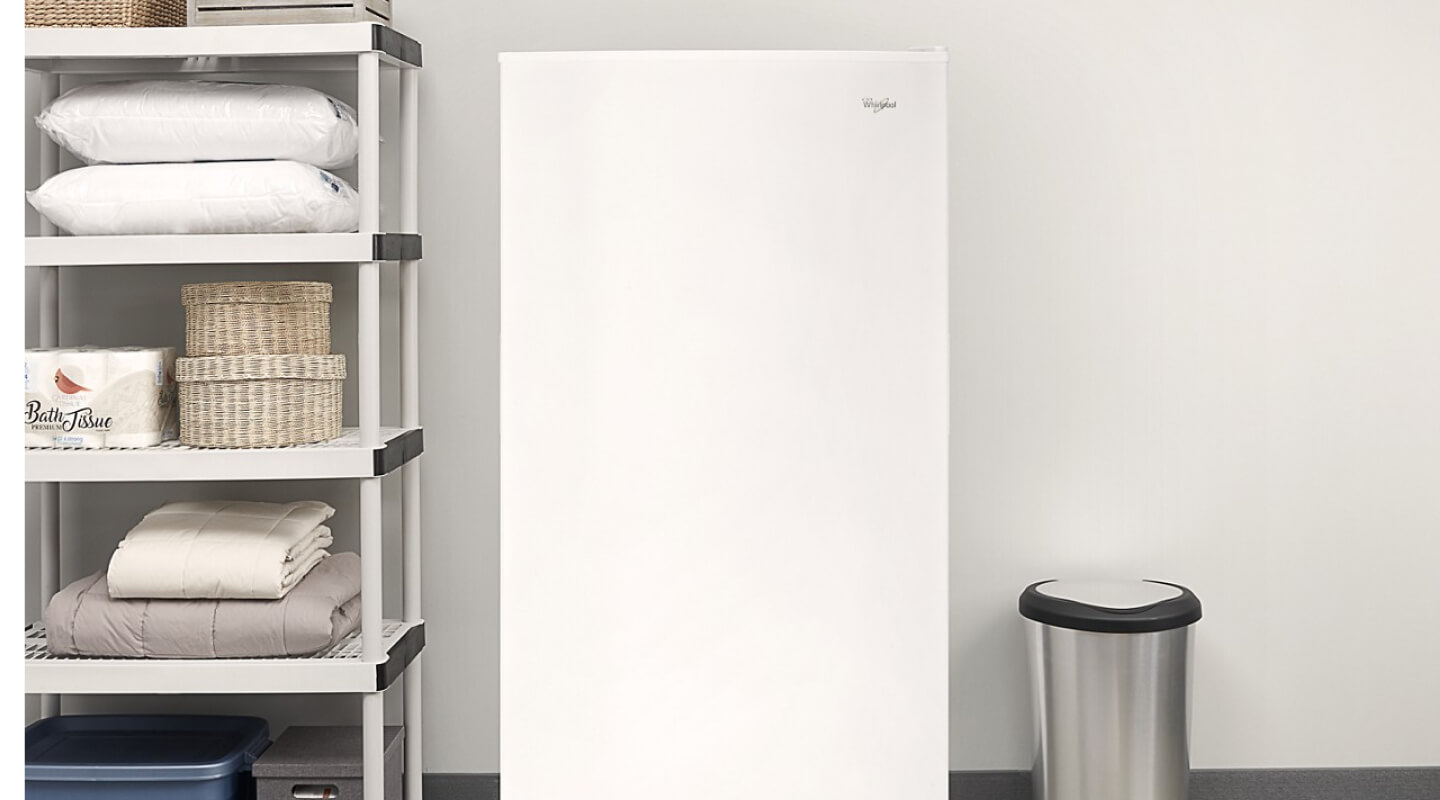 White Whirlpool® Upright Freezer along garage wall