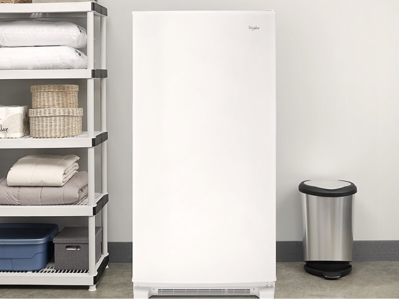 White Whirlpool® Upright Freezer along garage wall
