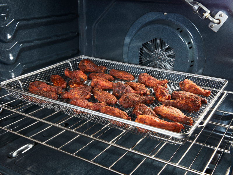 Chicken wings in an air fryer basket