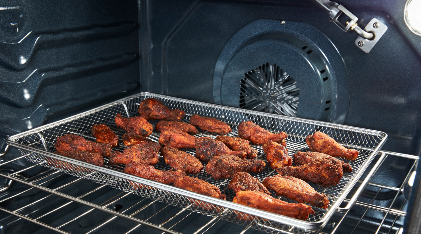 Chicken wings in an air fryer basket