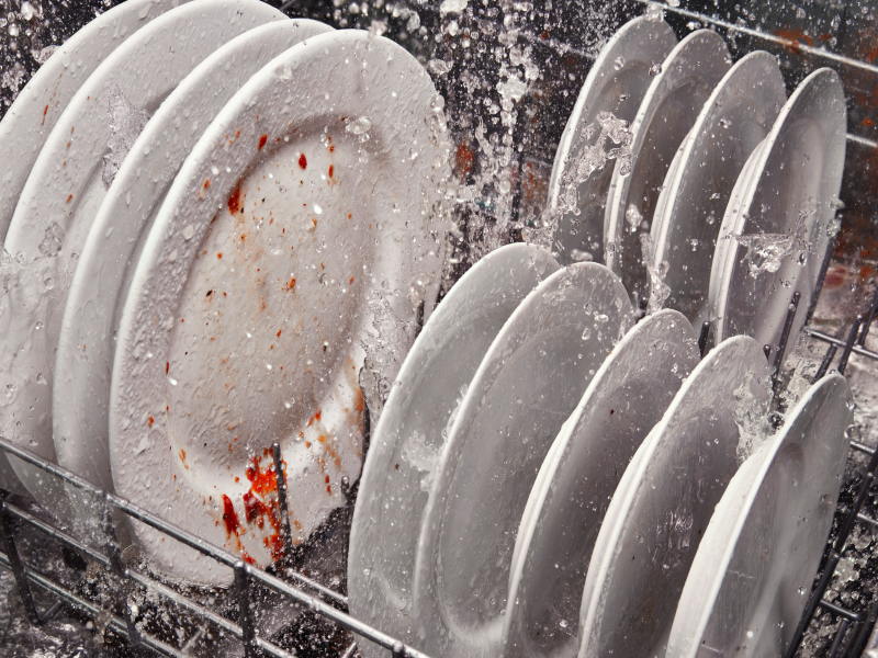 Dirty dishes inside a running dishwasher