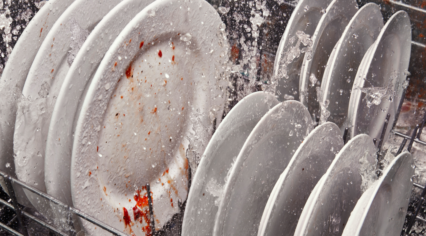 Dirty dishes inside a running dishwasher