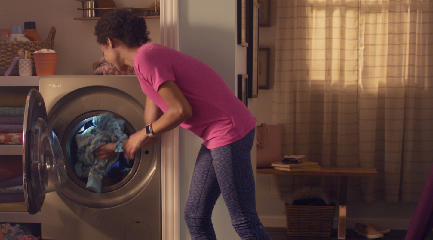 Person removing clothes from a dryer