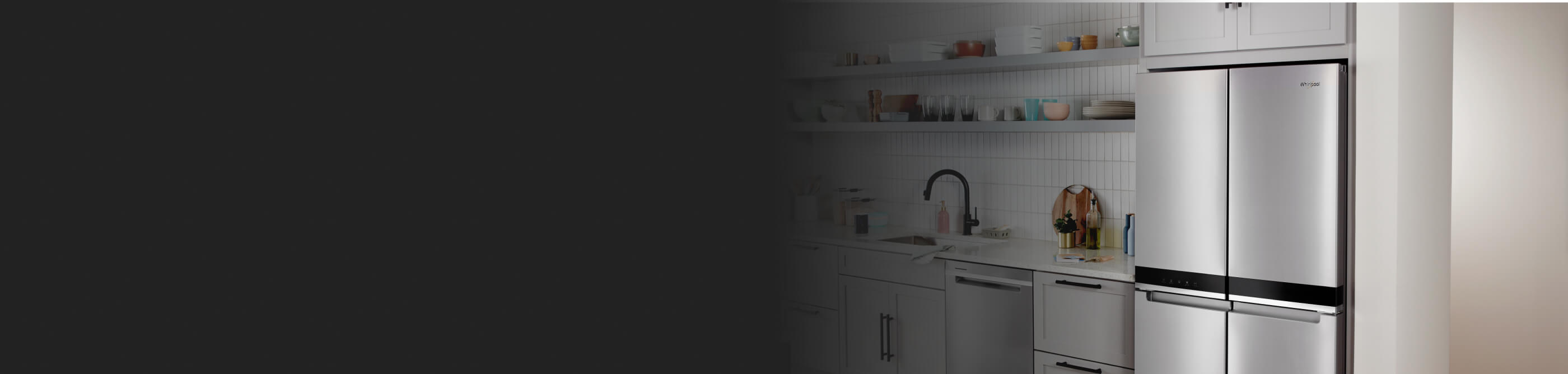 The inside of a kitchen with a counter-depth, stainless steel refrigerator