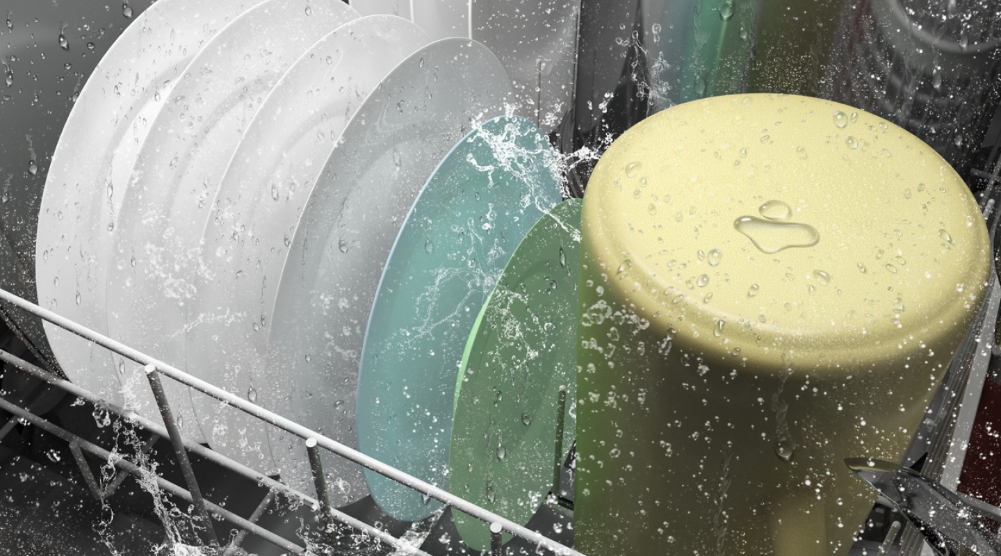 Dishes inside a dishwasher in the middle of a wash cycle