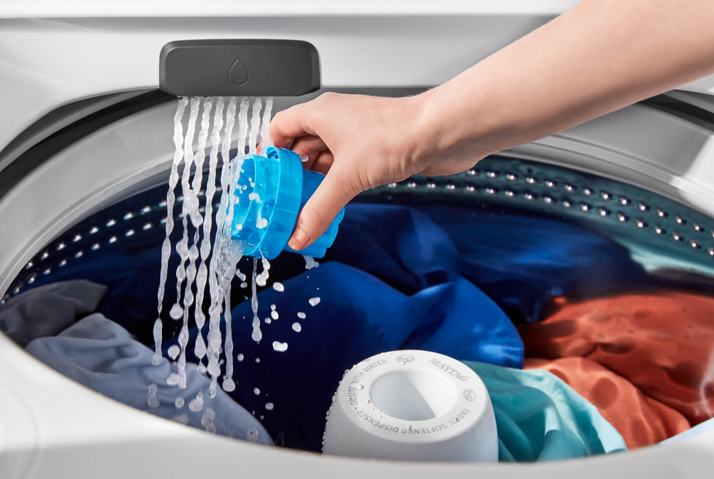 Person pouring detergent in washing machine