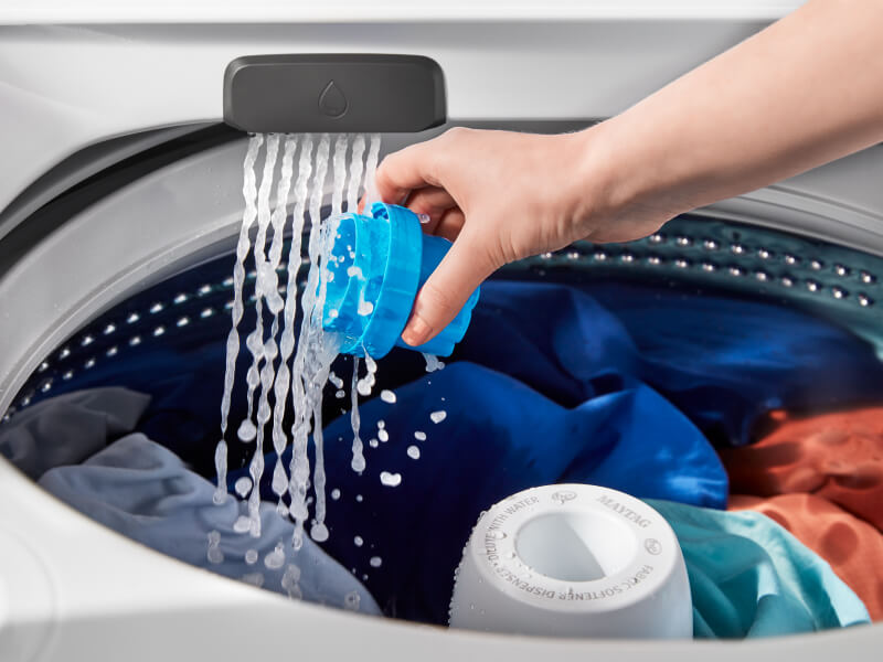 Person pouring detergent in washing machine