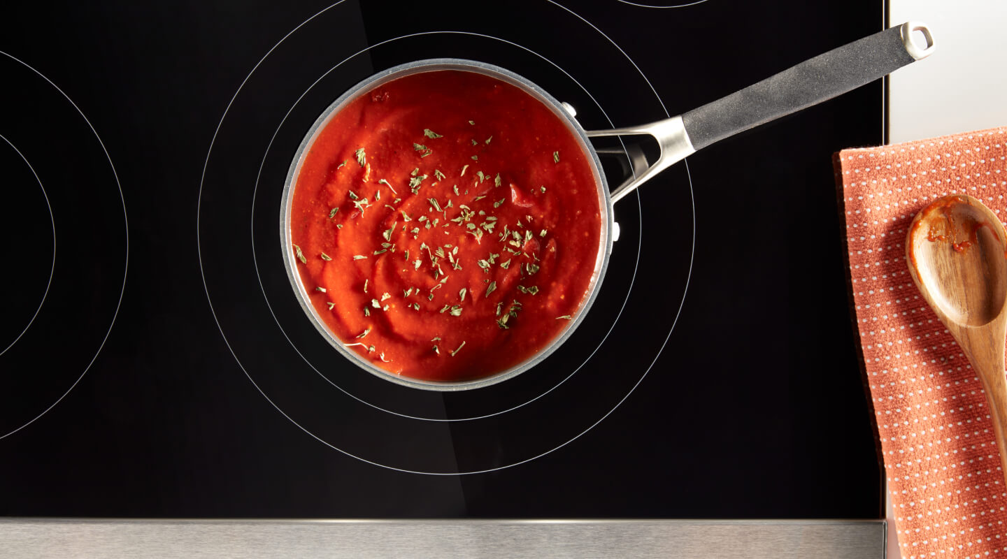 Tomato soup in a saucepan on an electric cooktop