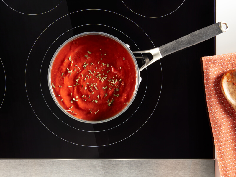 Tomato soup in a saucepan on an electric cooktop