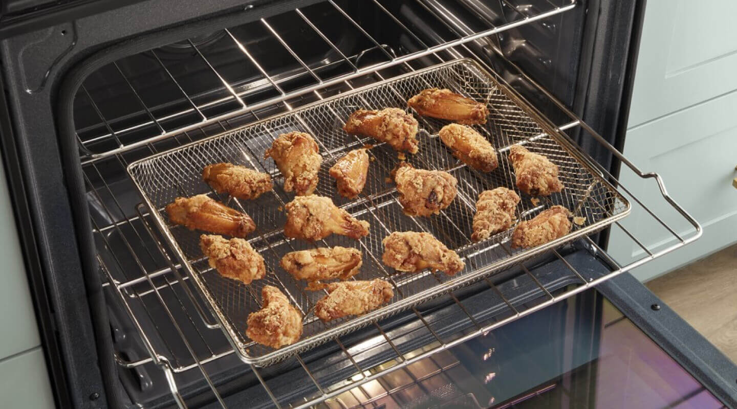 Wings on the Air Fryer Basket inside a Whirlpool® Gas Range