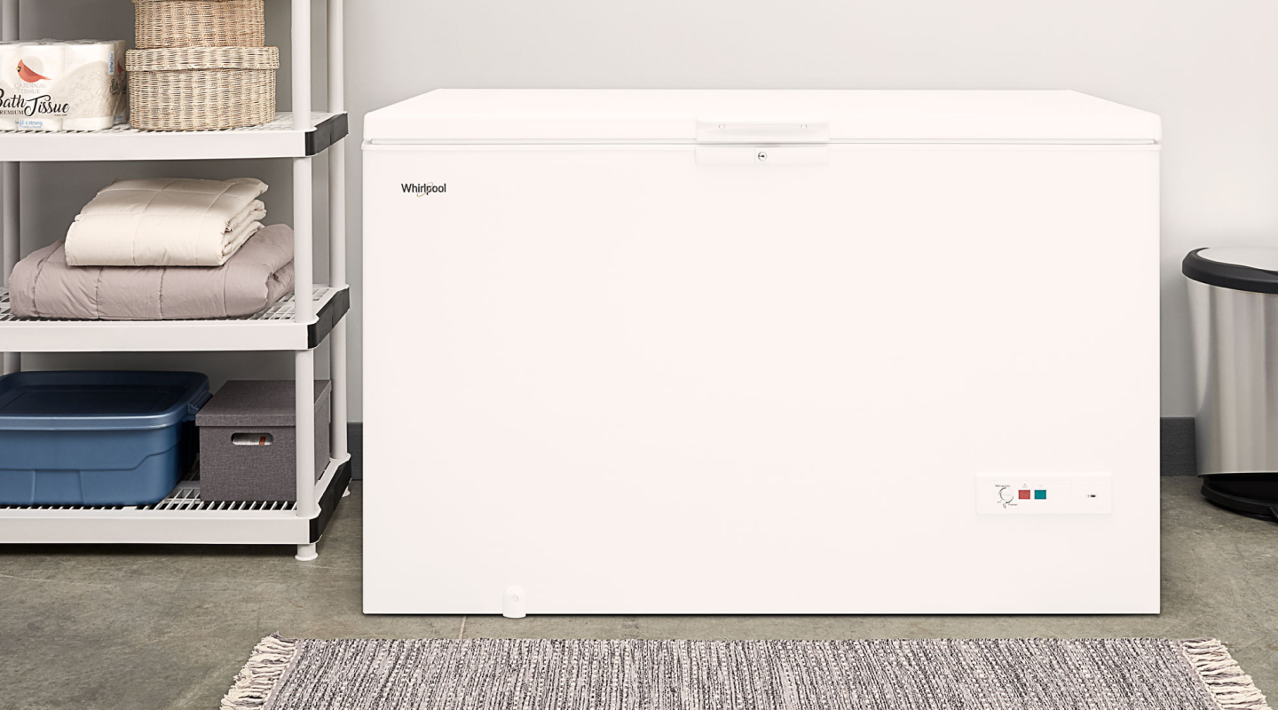 A chest deep freezer in a laundry room