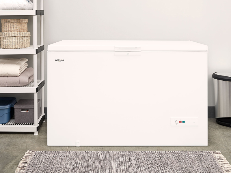 A chest deep freezer in a laundry room