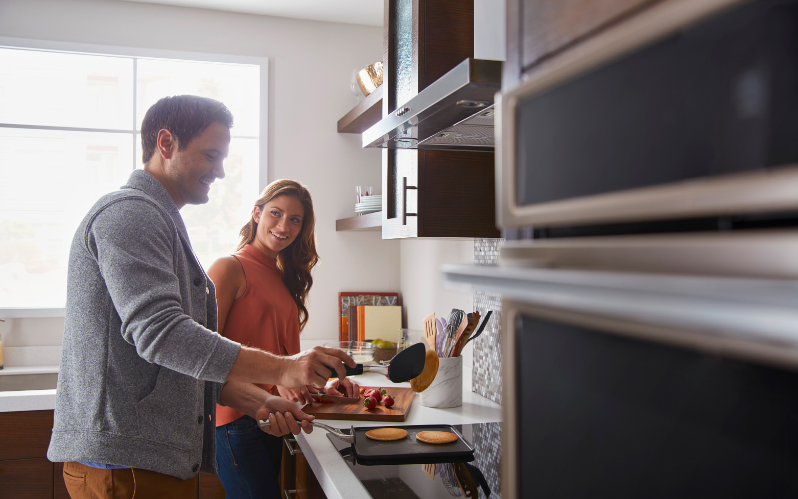 Man and woman preparing food in a kitchen