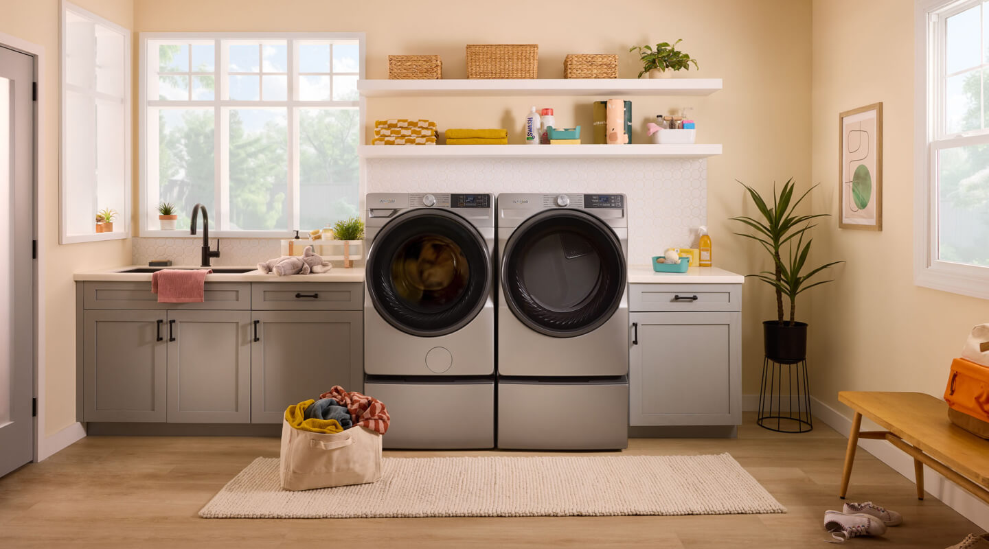 A Whirlpool® Washer and Dryer in a light colored laundry area