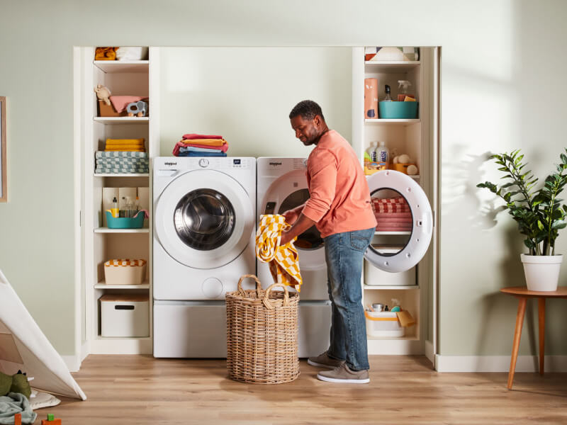 A person pulling clothes out of a dryer