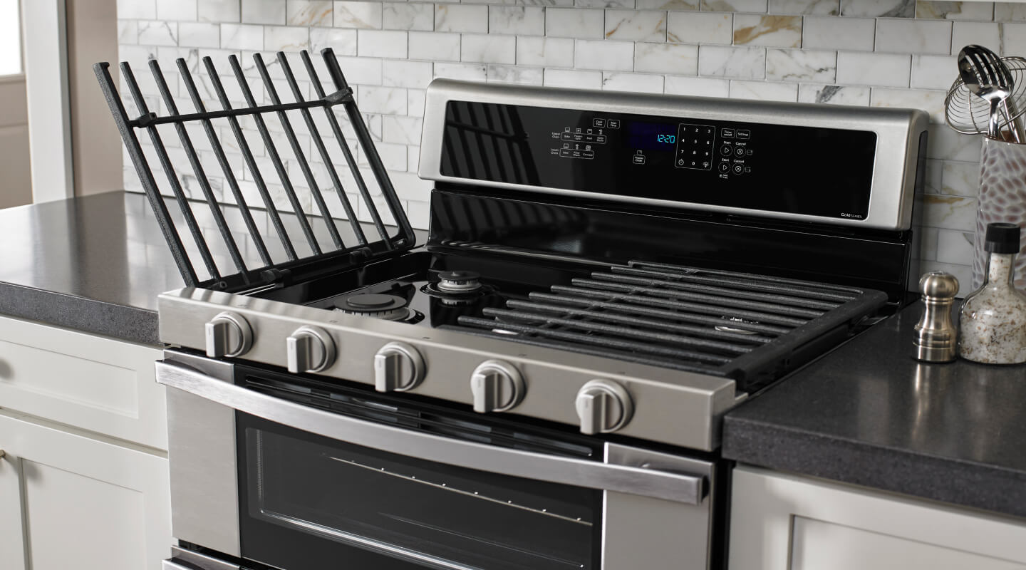 Hinged grates open on top of a gas range
