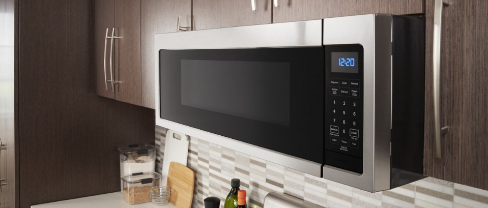 A Whirlpool® microwave installed over a range