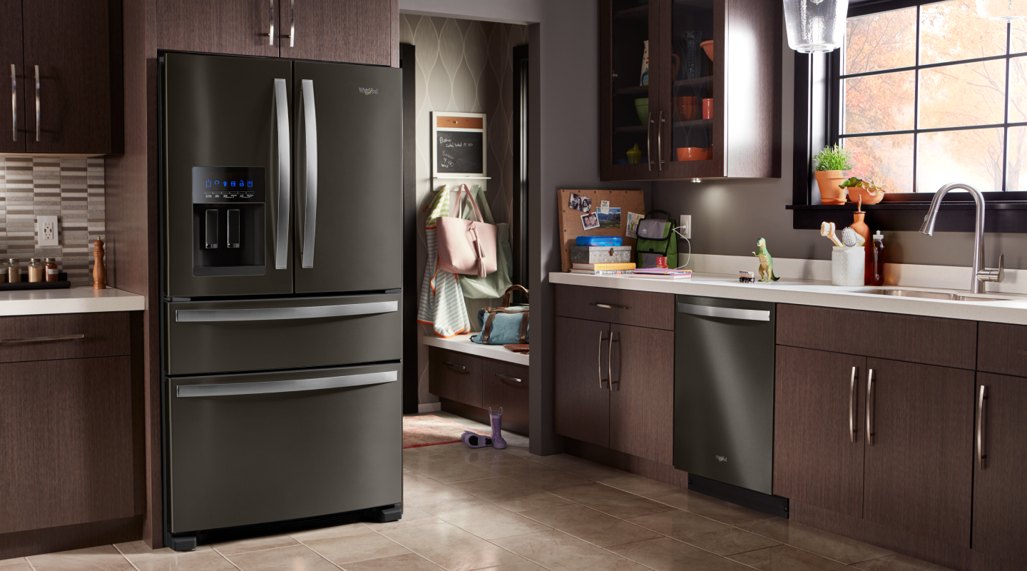 Whirlpool brand multi-door refrigerator in brown cabinetry