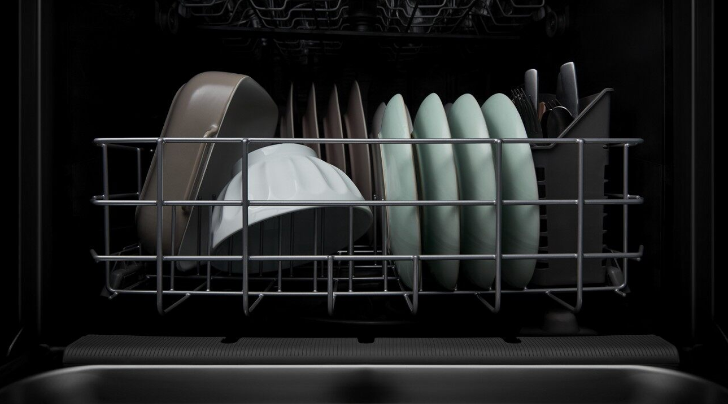 A closeup of the bottom rack of a Whirlpool® dishwasher with clean dishware.