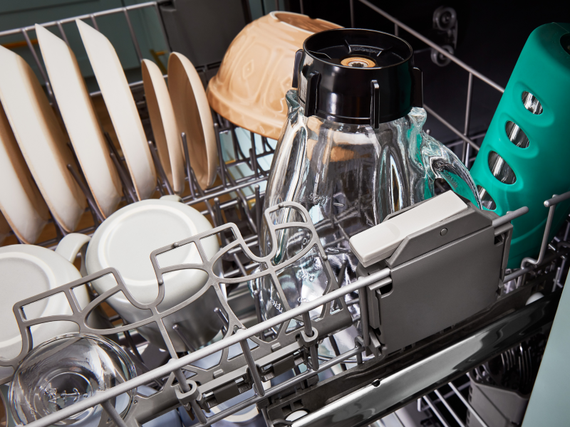 The bottom rack of a Whirlpool® dishwasher filled with dishes.