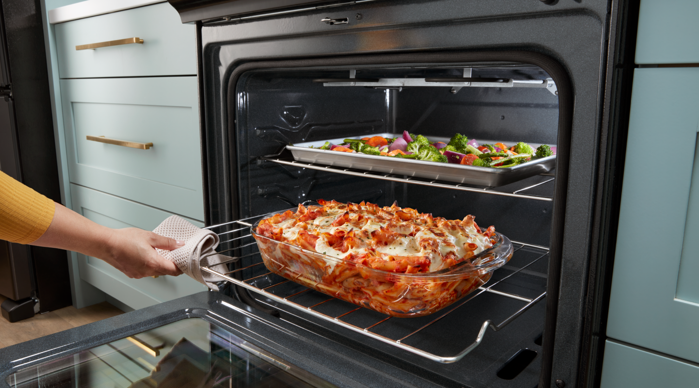 Baked pasta and roasted vegetables inside a Whirlpool® oven
