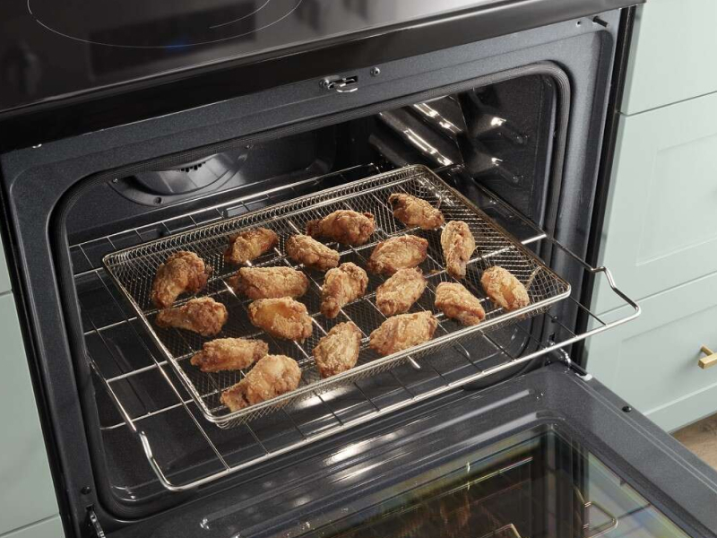A closeup of a Whirlpool® oven with air fried food.