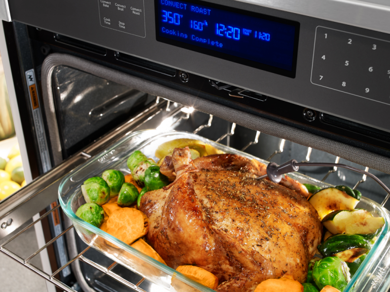 A meat probe pressed into a roasted chicken