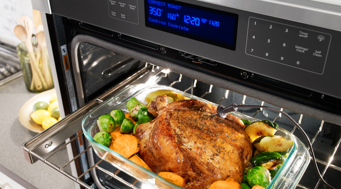 A meat probe pressed into a roasted chicken