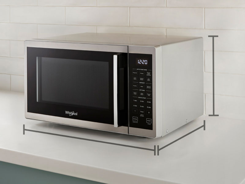 Black and silver countertop microwave with dimension markers infographic